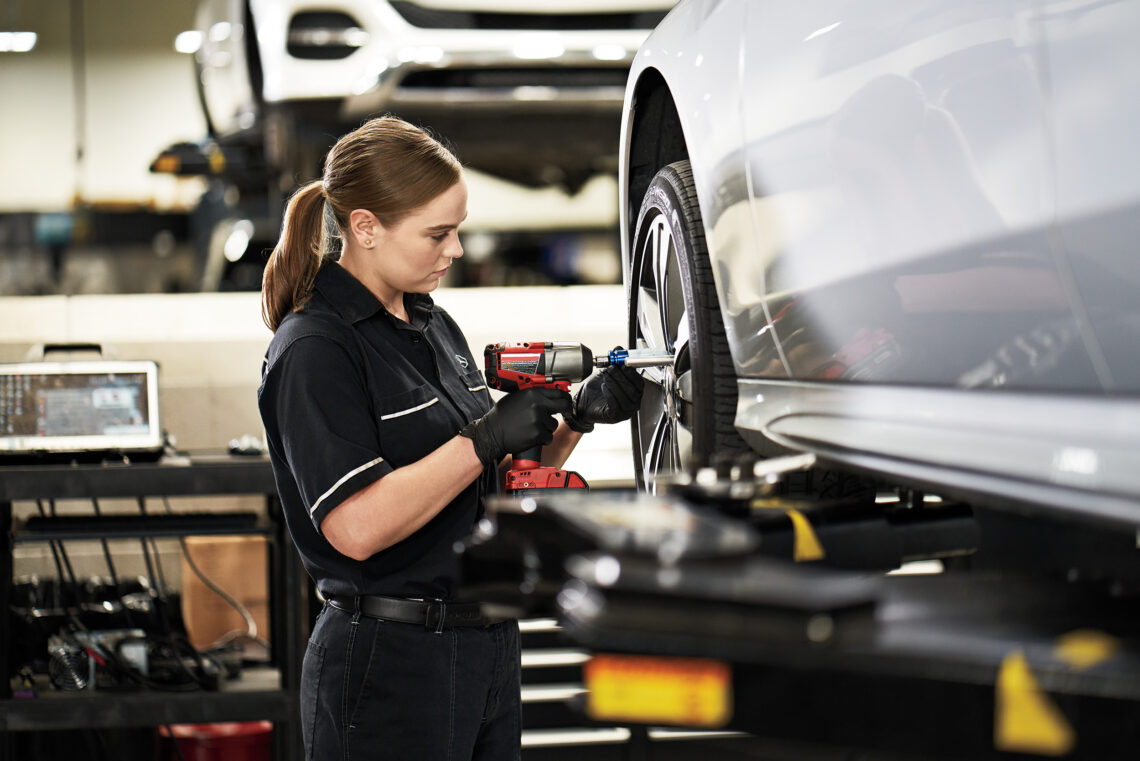 female Mercedes-Benz technician changing a tire