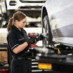 female Mercedes-Benz technician changing a tire