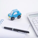 Notepad, calculator, and a toy car