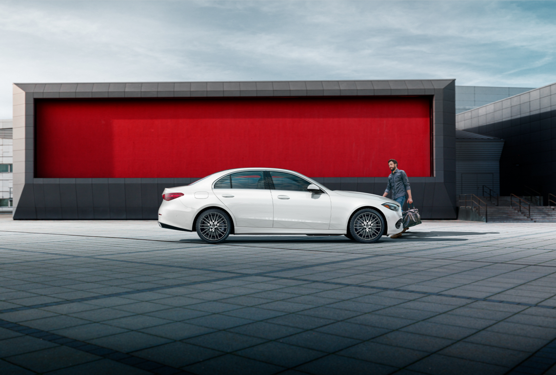white 2026 Mercedes-Benz C-Class sedan and a man