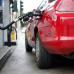 Filling gas in a red car