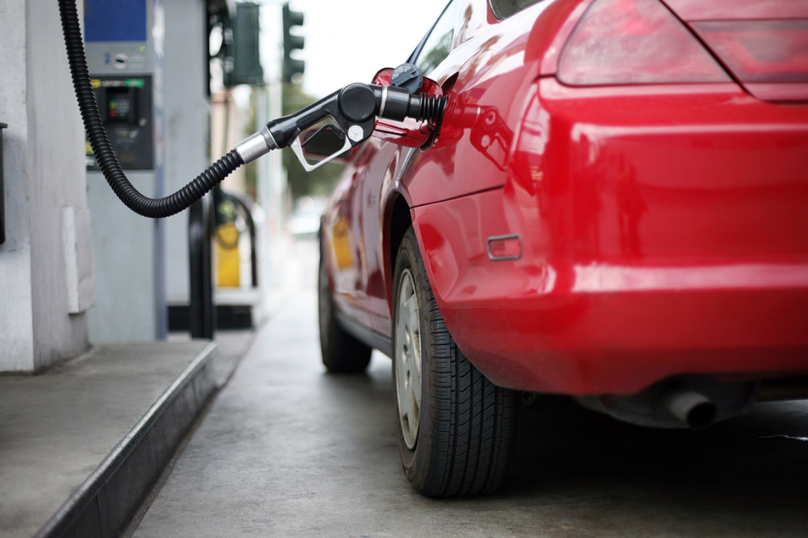 Filling gas in a red car
