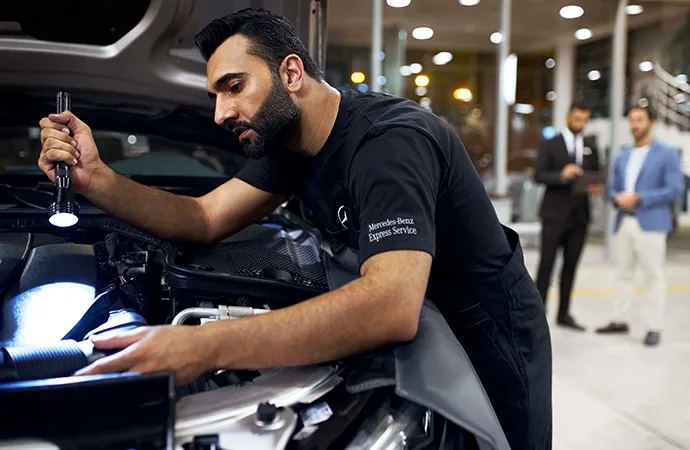 Merecedes-Benz technician performing an inspection
