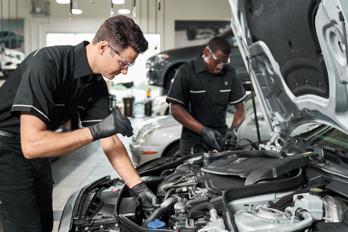 Mercedes-Benz service technicians inspecting vehicles